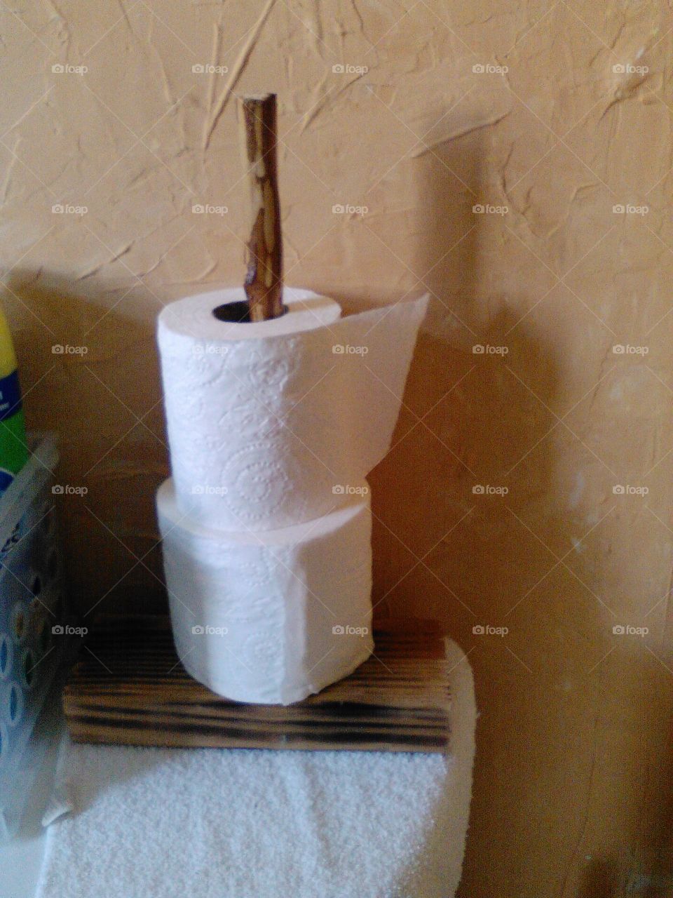 Handmade toilet paper holder. I made this out of tree sticks an wood.