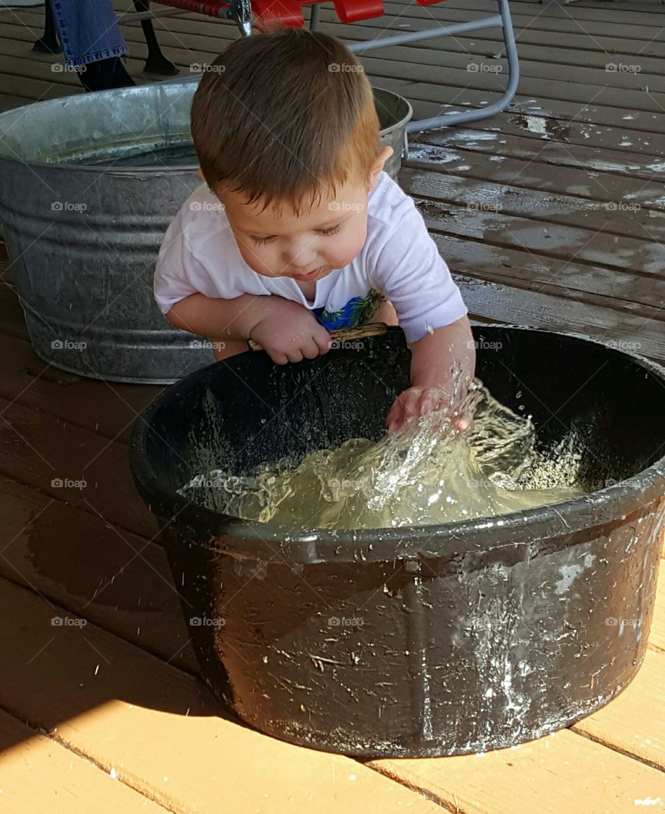 Cute toddler playing with water