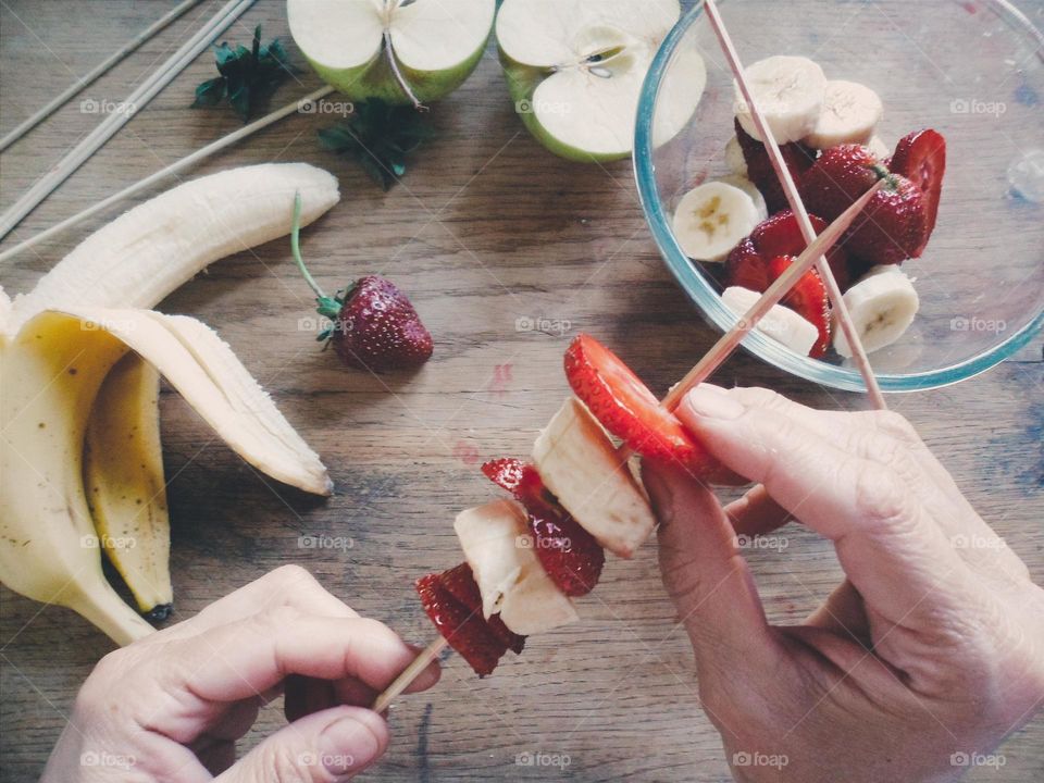 Person preparing fruit salad