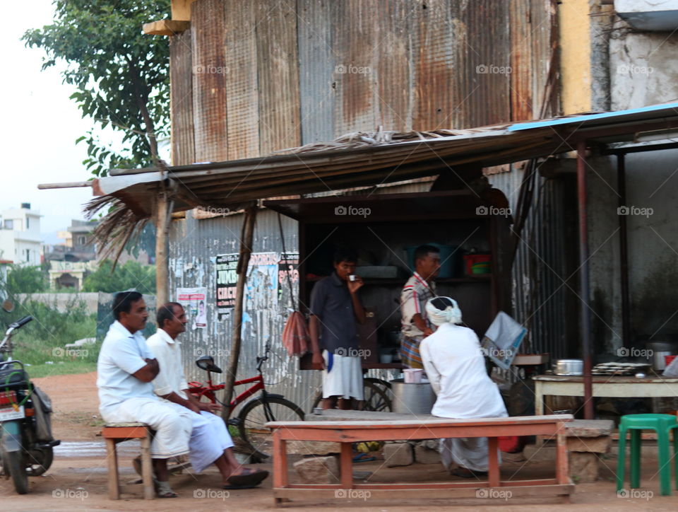 people sitting beside street