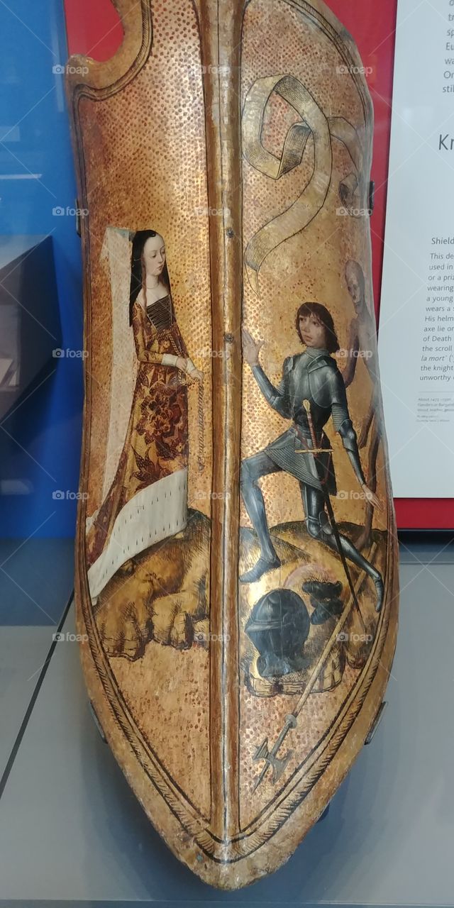medieval painted shield with design of knight and noble lady