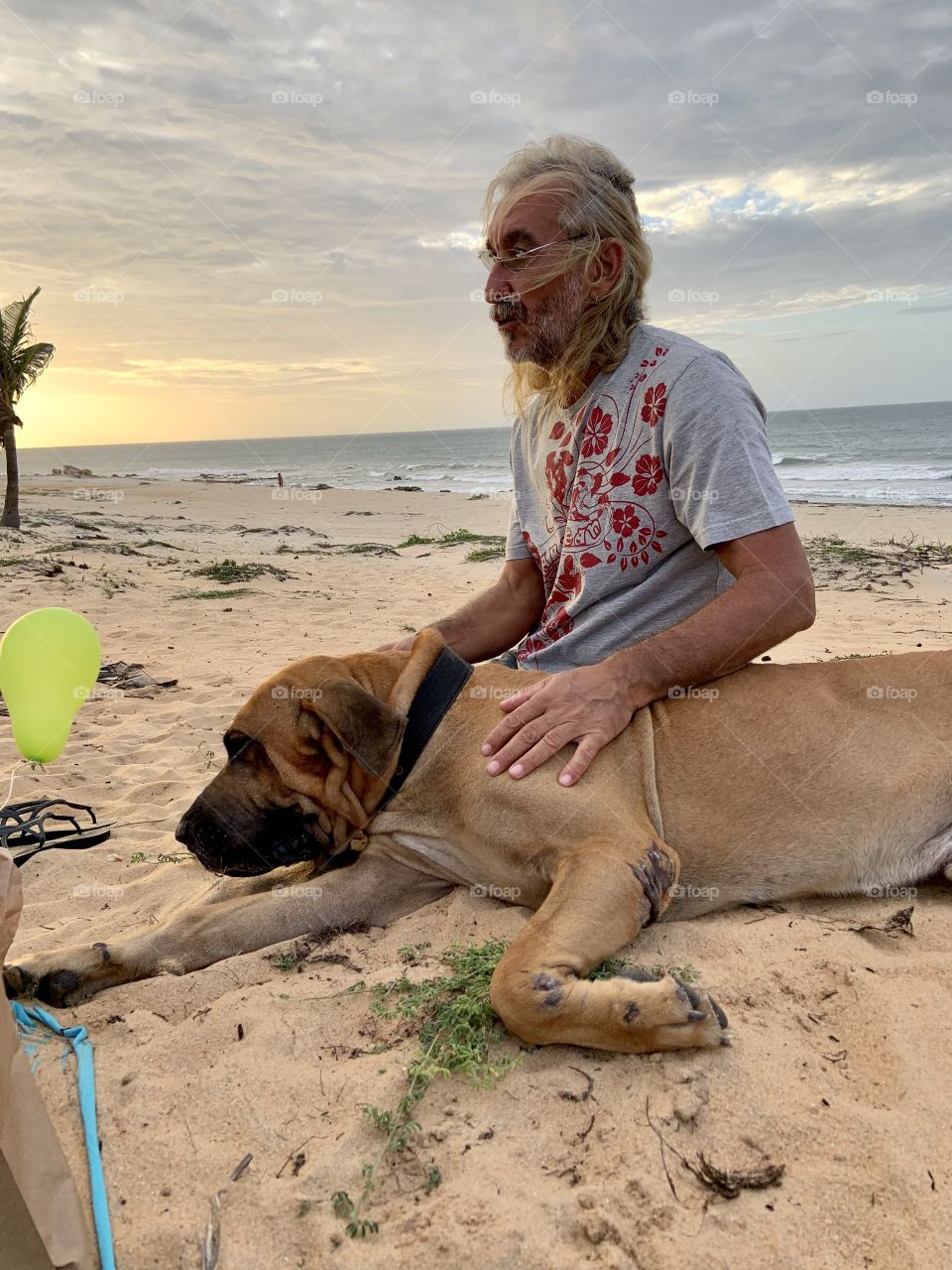 Man with dog in the beach 