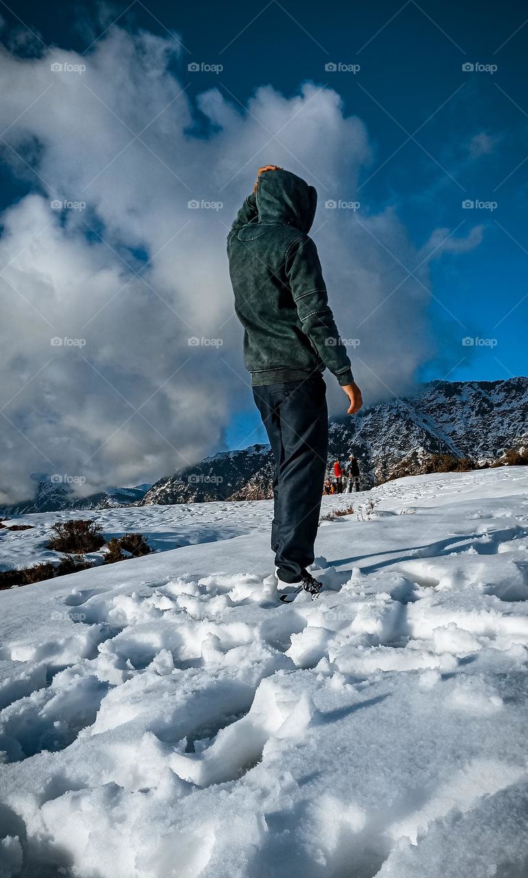 A man amazed with the beauty of snow on mountain.