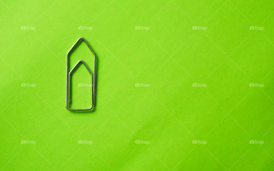 Paperclip on green background