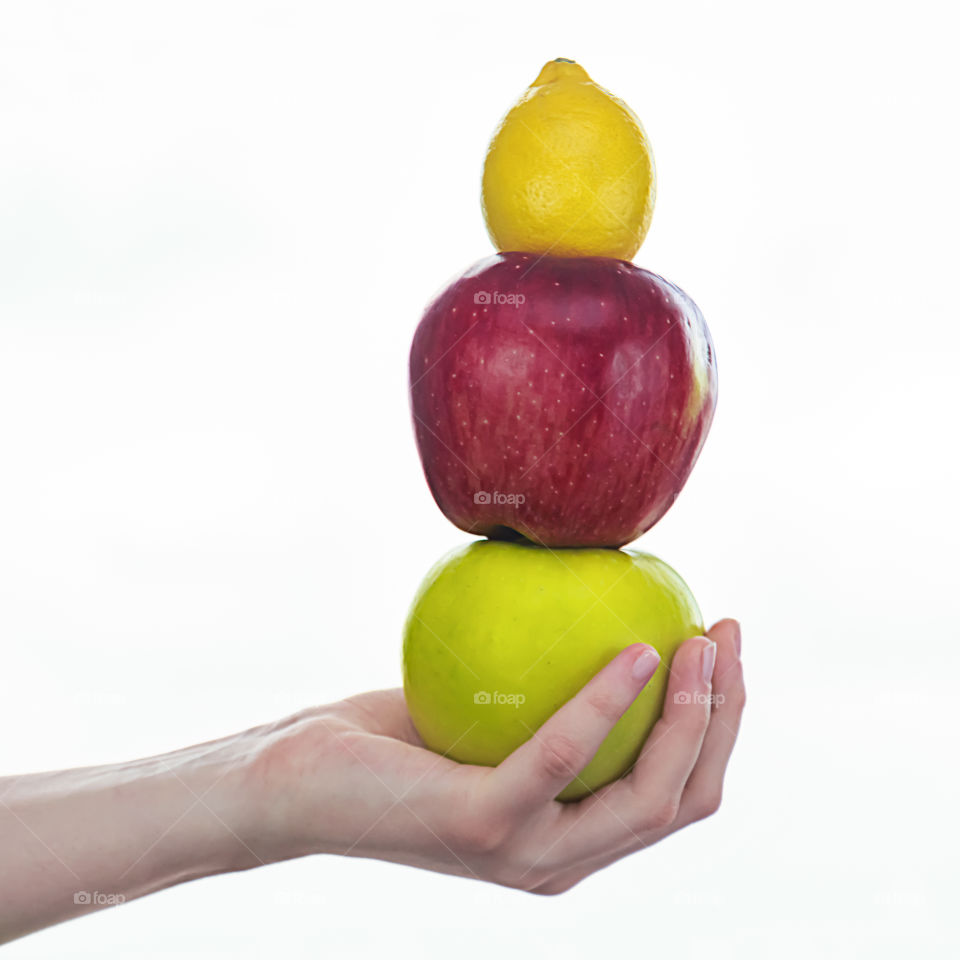 Studio shot of hand holding fruits