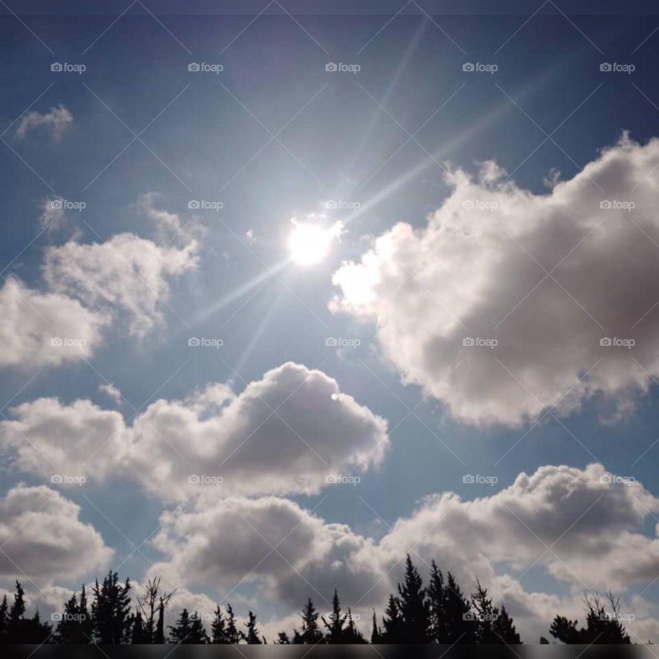 The sky becomes more beautiful when the sun and clouds meet in the blue sky