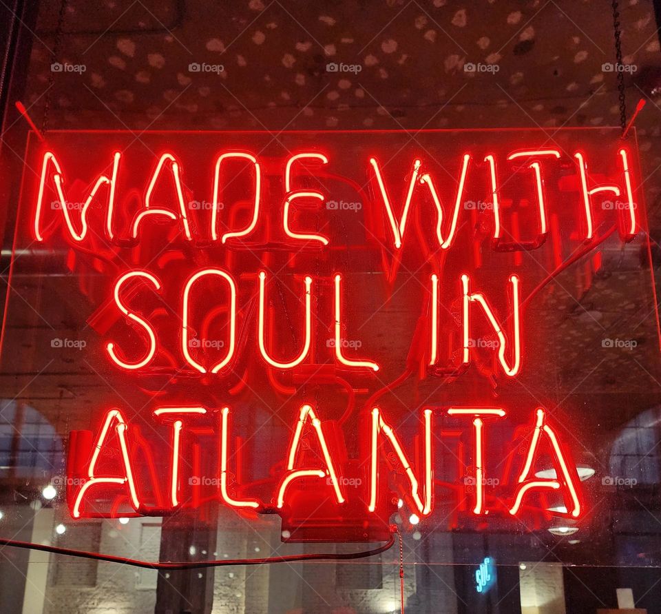 A bright red neon sign glows in a downtown Atlanta window showing the pride the residents have for their city