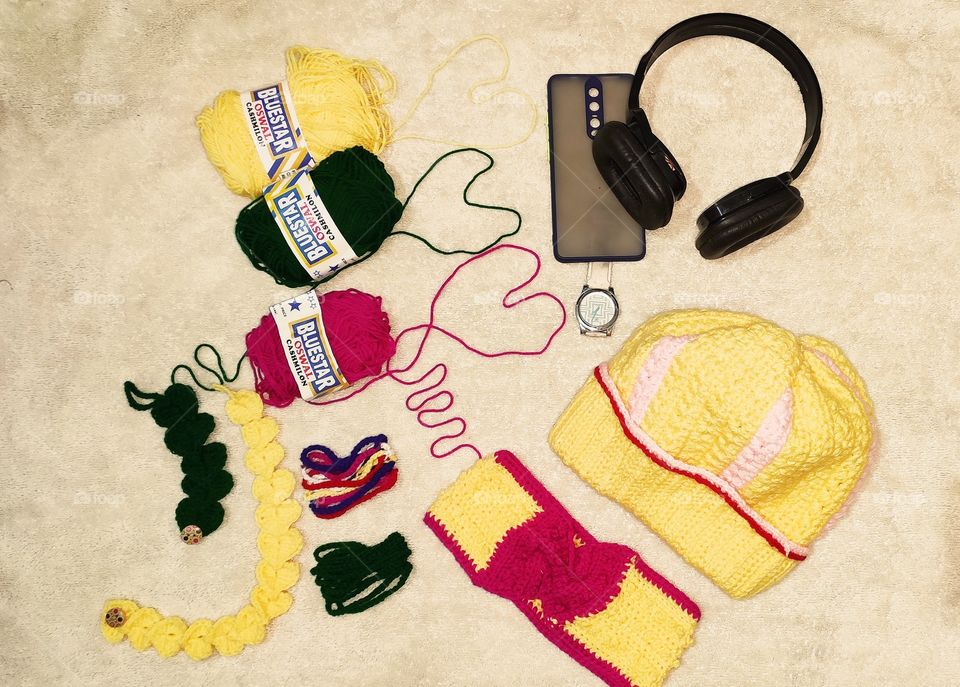 Flat layout of My Crochet art - a winter cap, headband, heart and multicolour braclet with music always on. Knowledge passed by my mother, so proud of myself to reach this point in Crochet. Gifted these to my friends and a crochet wallet to my mom😁.