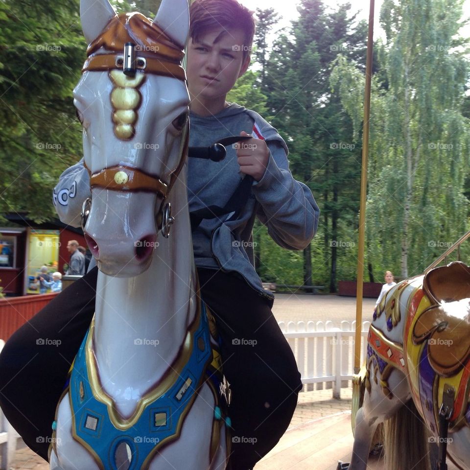 Boy on tivoli carousel horse