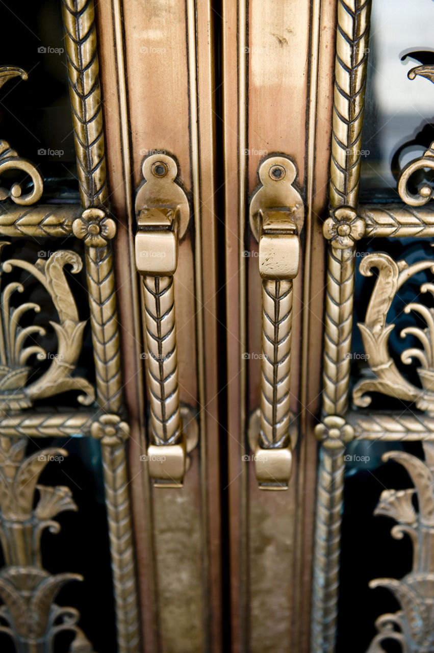 Closeup image of bronze doors with glass