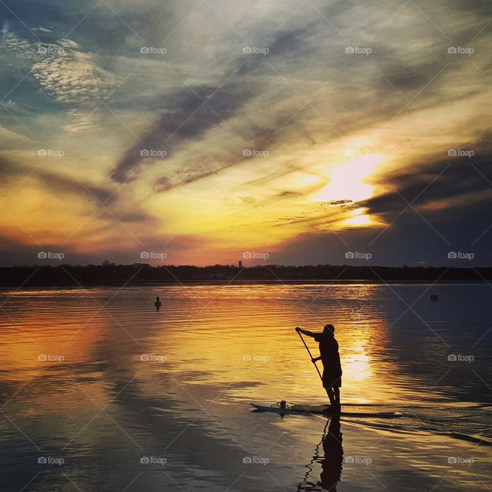 paddle boarding along. took this photo during a sunset 