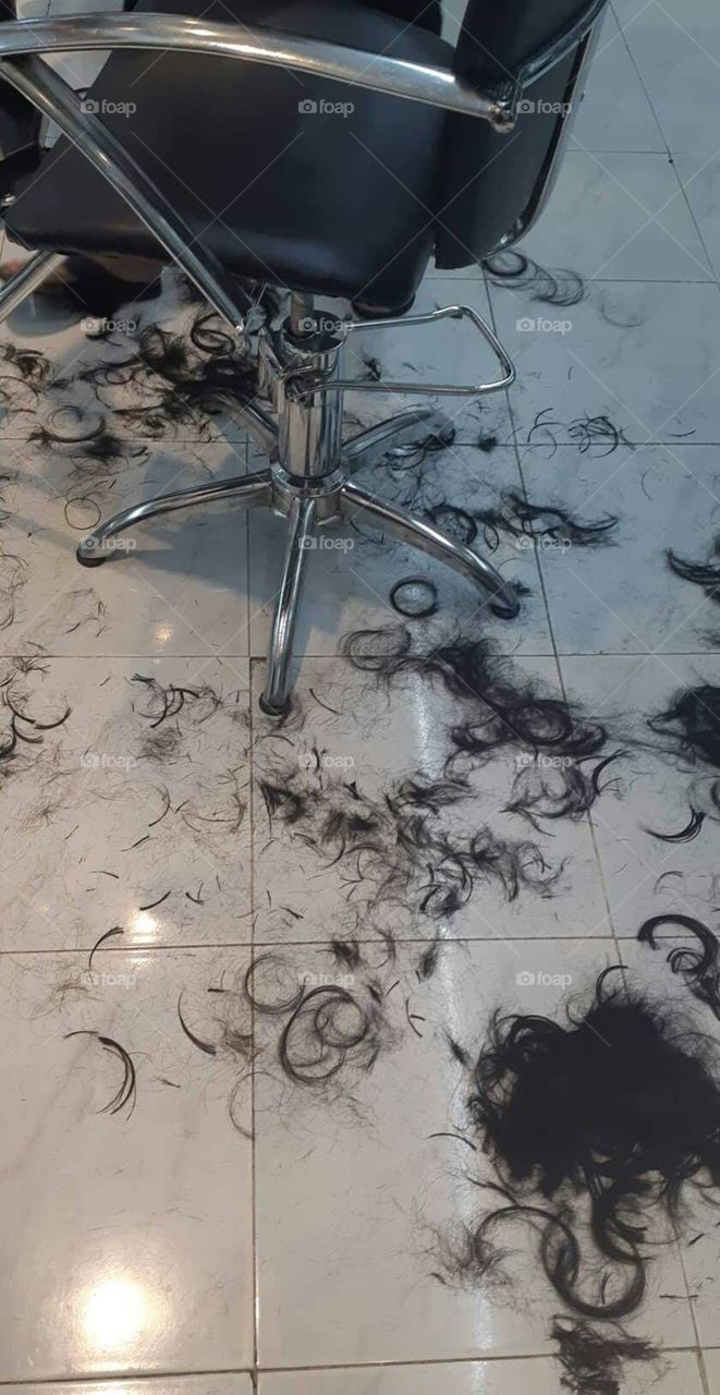 A photo of an actual cut hair on the floor of a salon.