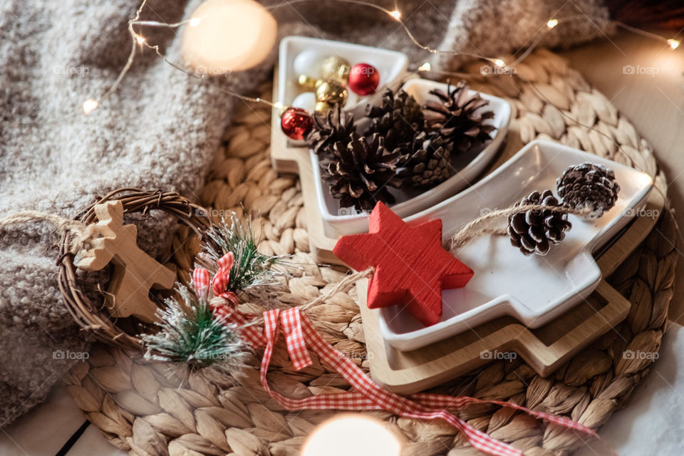 Christmas decorations cones, balls and wooden toys, red and beige colors, rustic stile