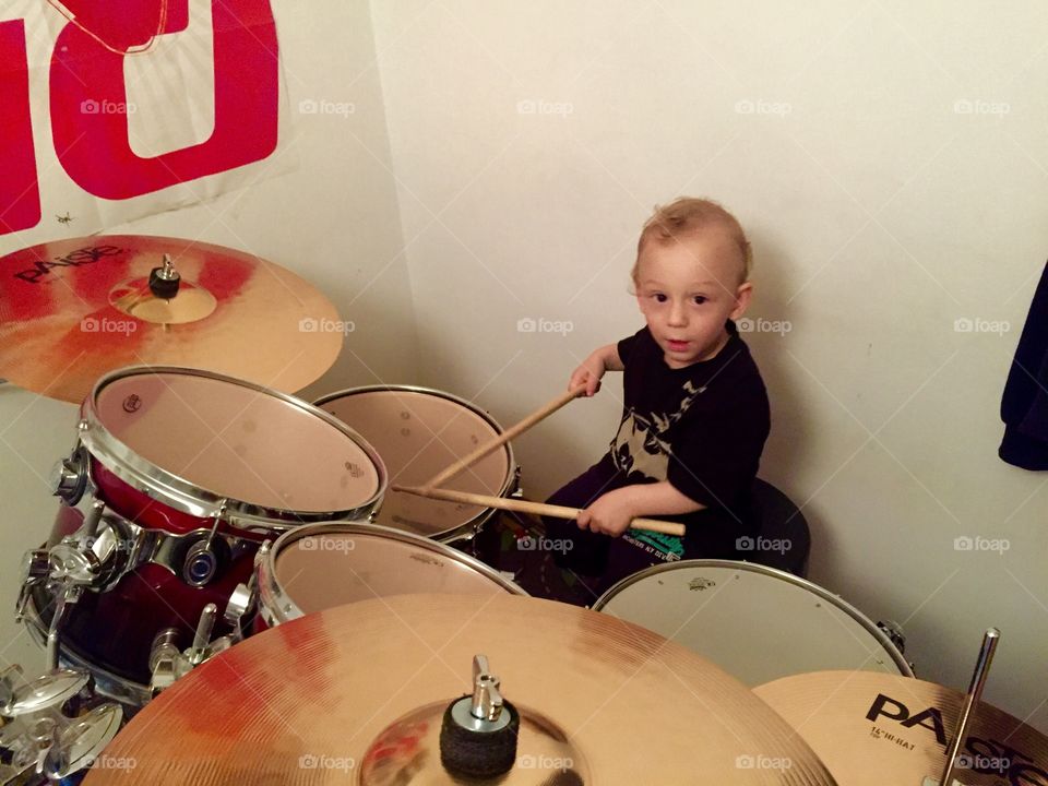 Small boy playing drums