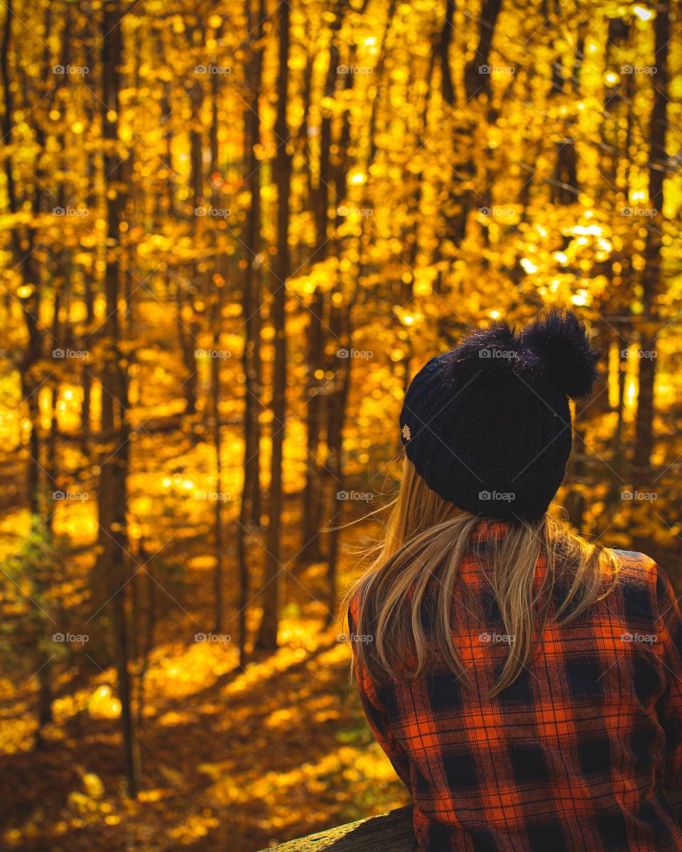 Woman enjoying the Golden trees in Autumn
