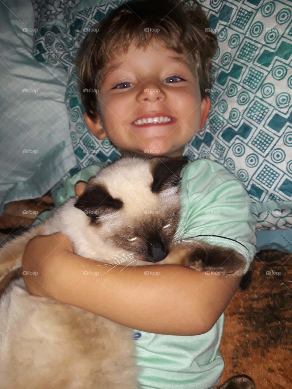 pretty child playing with the kitten