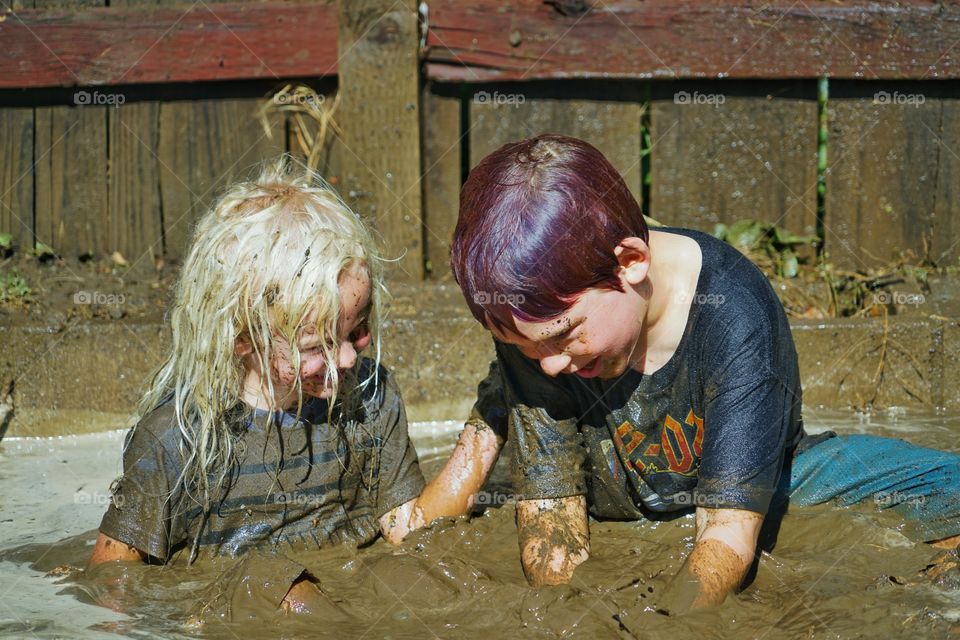 Kids Playing In The Mud