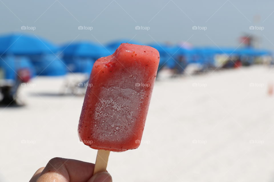 Having a strawberry ice cream on the beach 