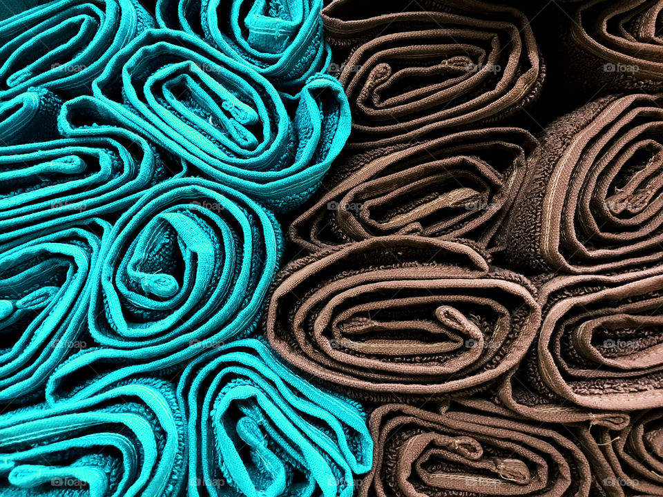 Colorful background made of wrapped blue and brown towels 