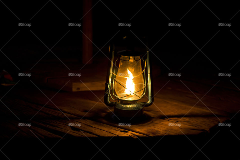 Lamp on a wooden table in the dark