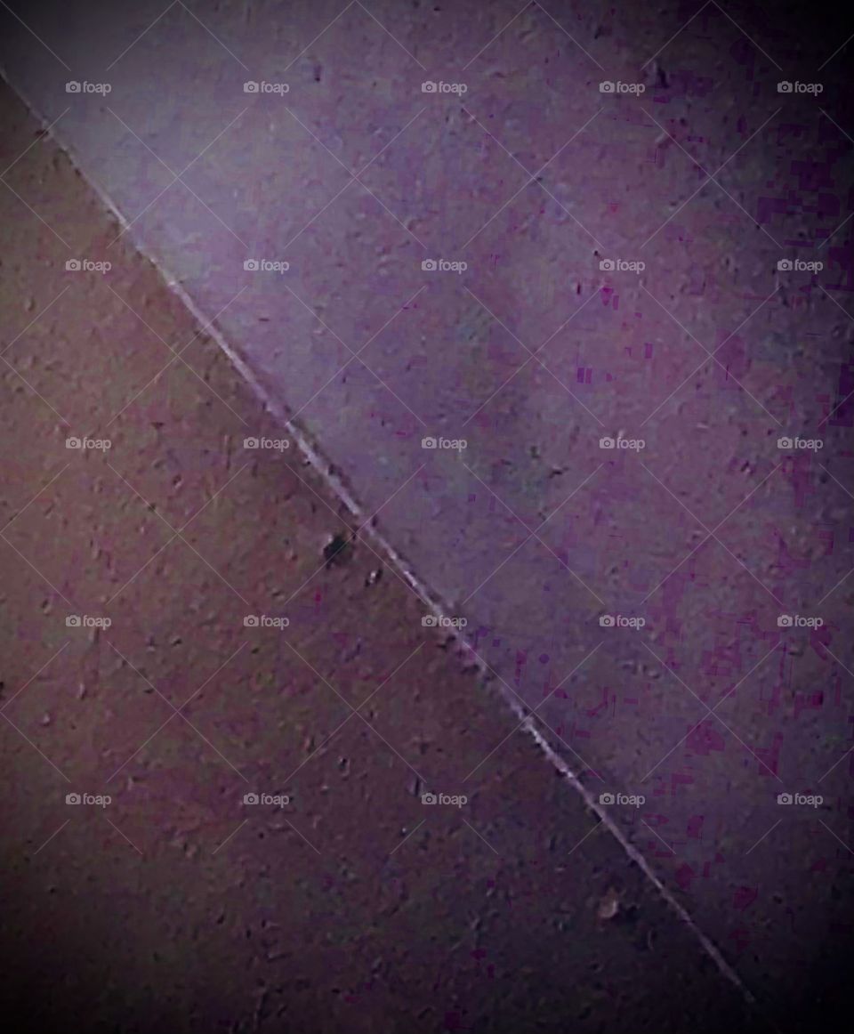 An abstract photo showing two nearly equal halves with different hues. It projects somewhat of a dark mood because of the appearances of the hues.