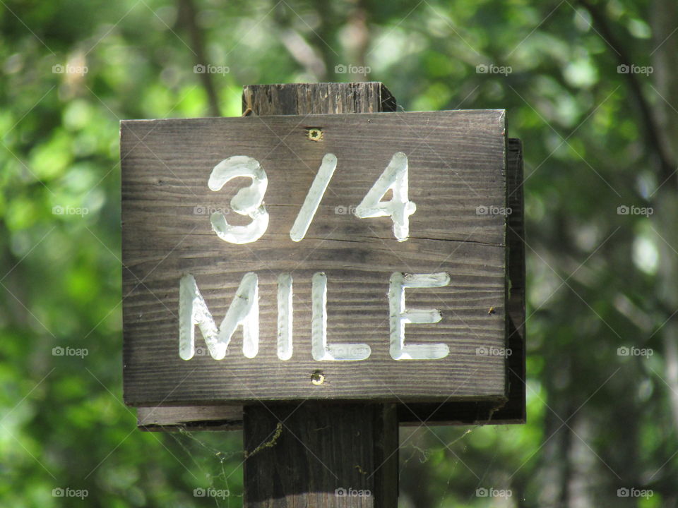 3/4 mile sign in the forest 