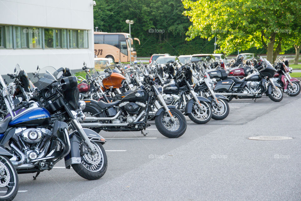 a large collection of motorcycles parked outside a hotel in Denmark.