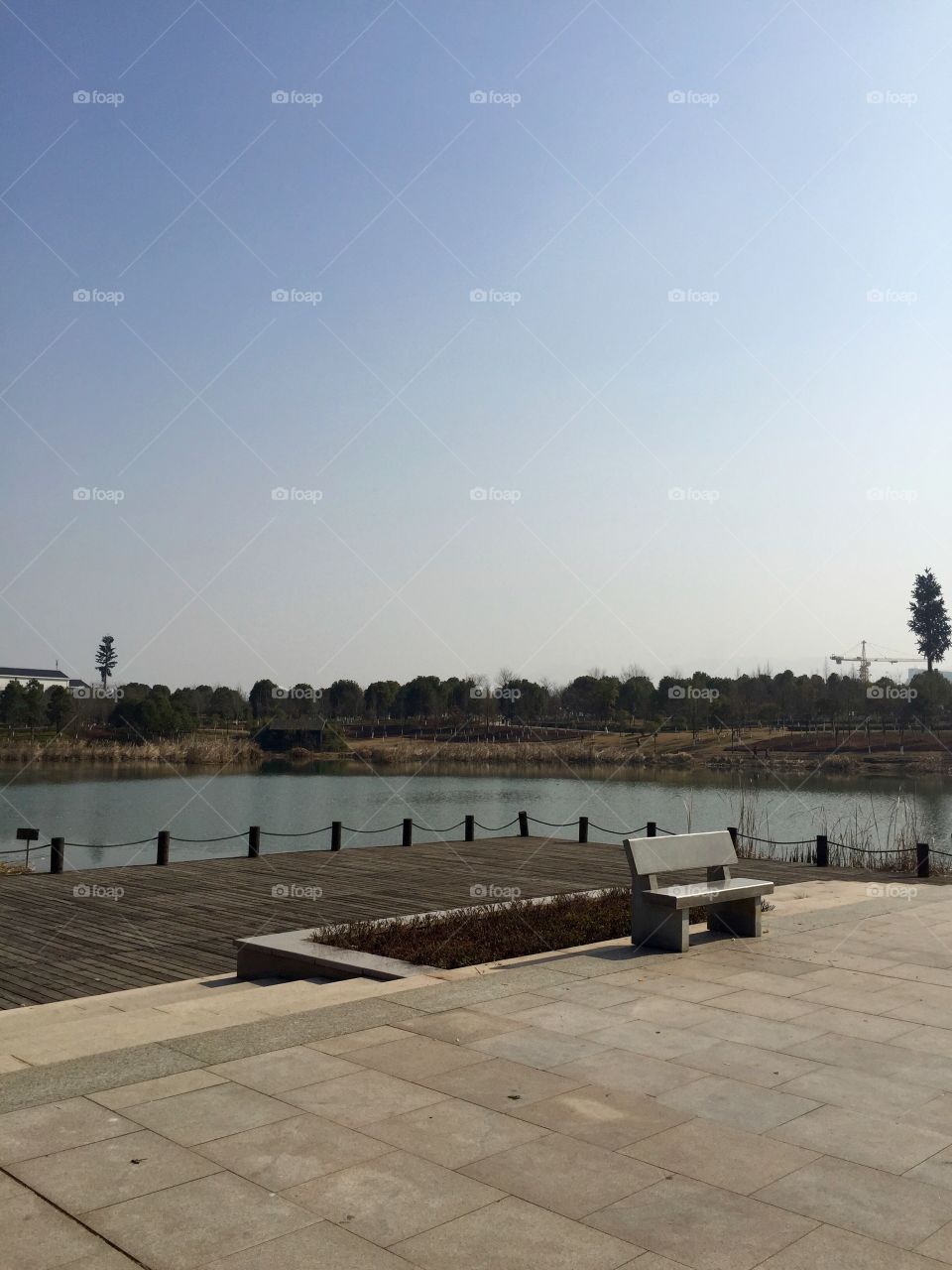 Pier with a bench on a lake in a Chinese park