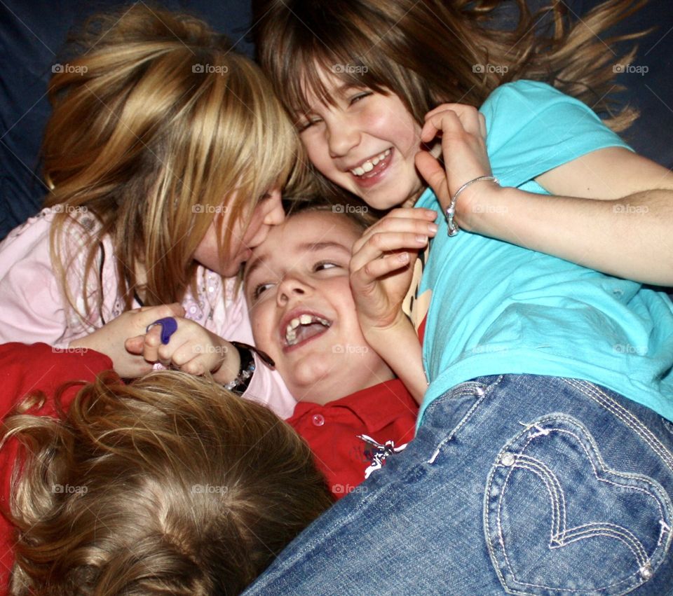 Cousins show their love with a pile up of hugs and kisses 
