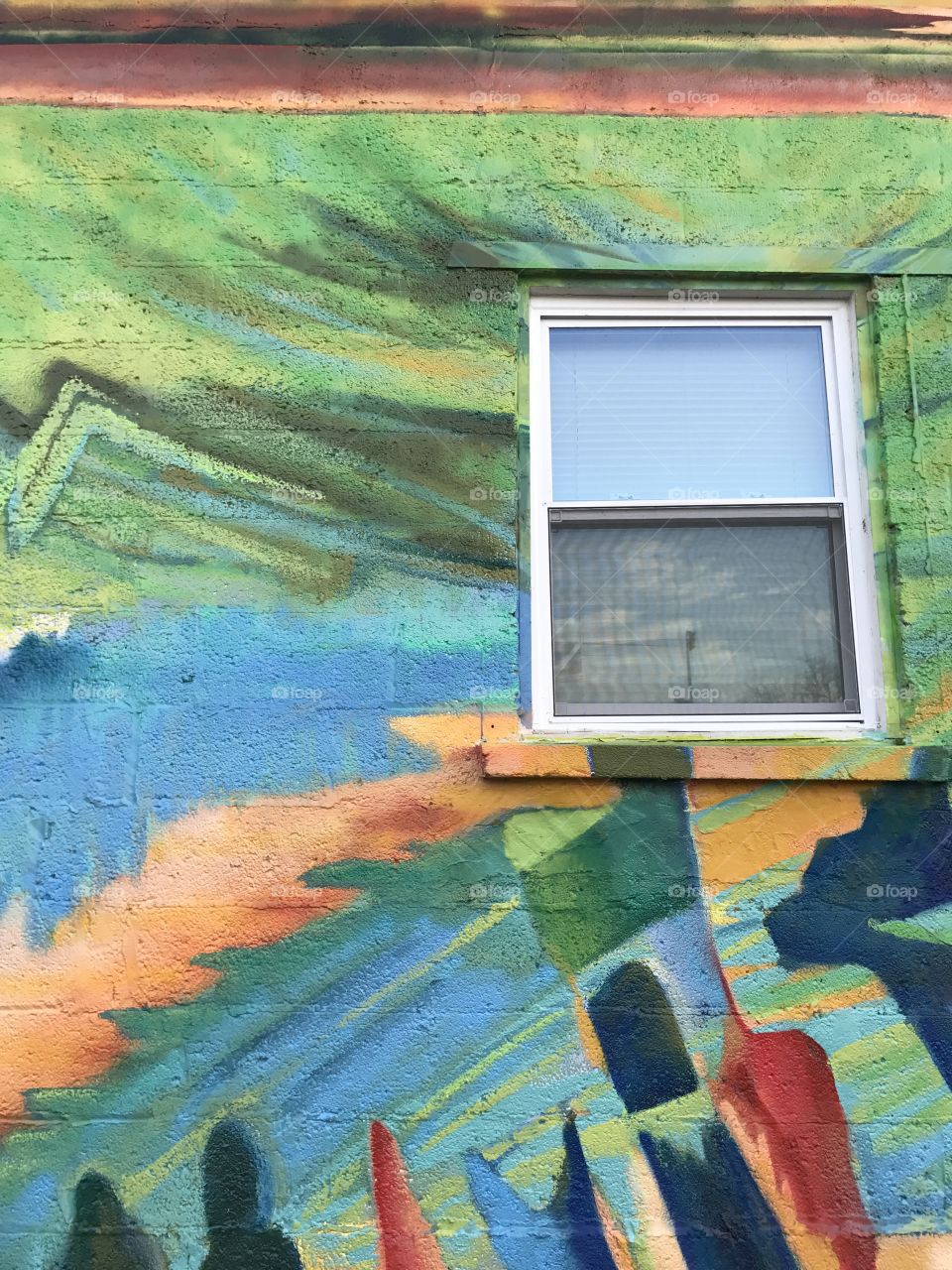 White window frame on colorfully painted building