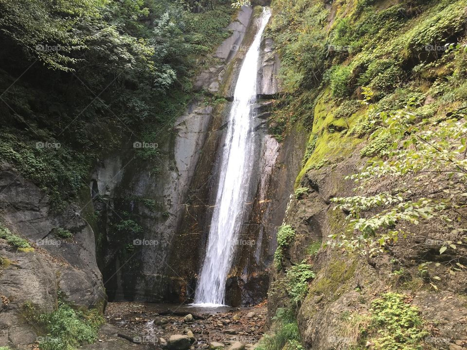 Waterfall between rocks with moss