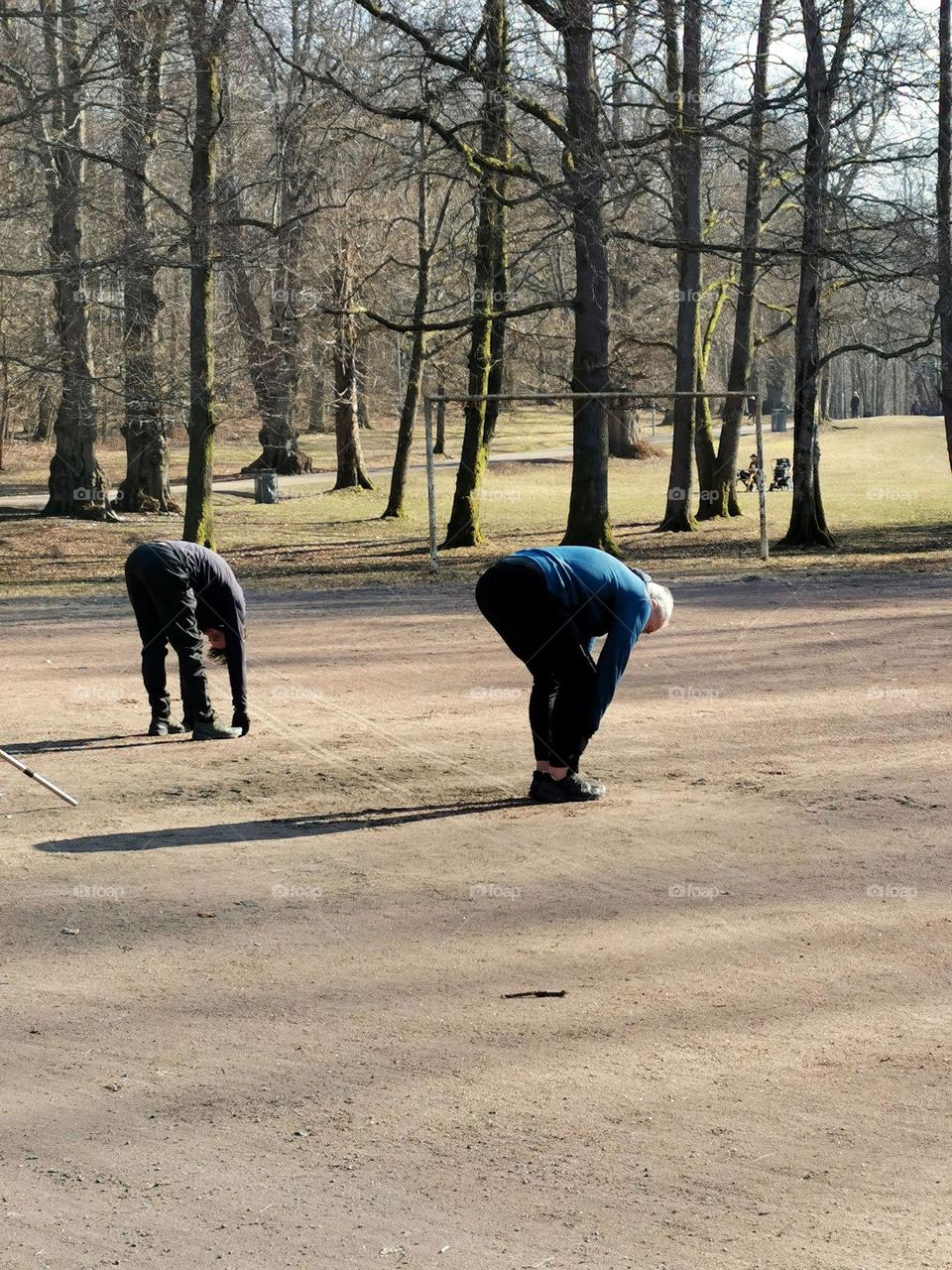 Men stretching doing yoga outdoors