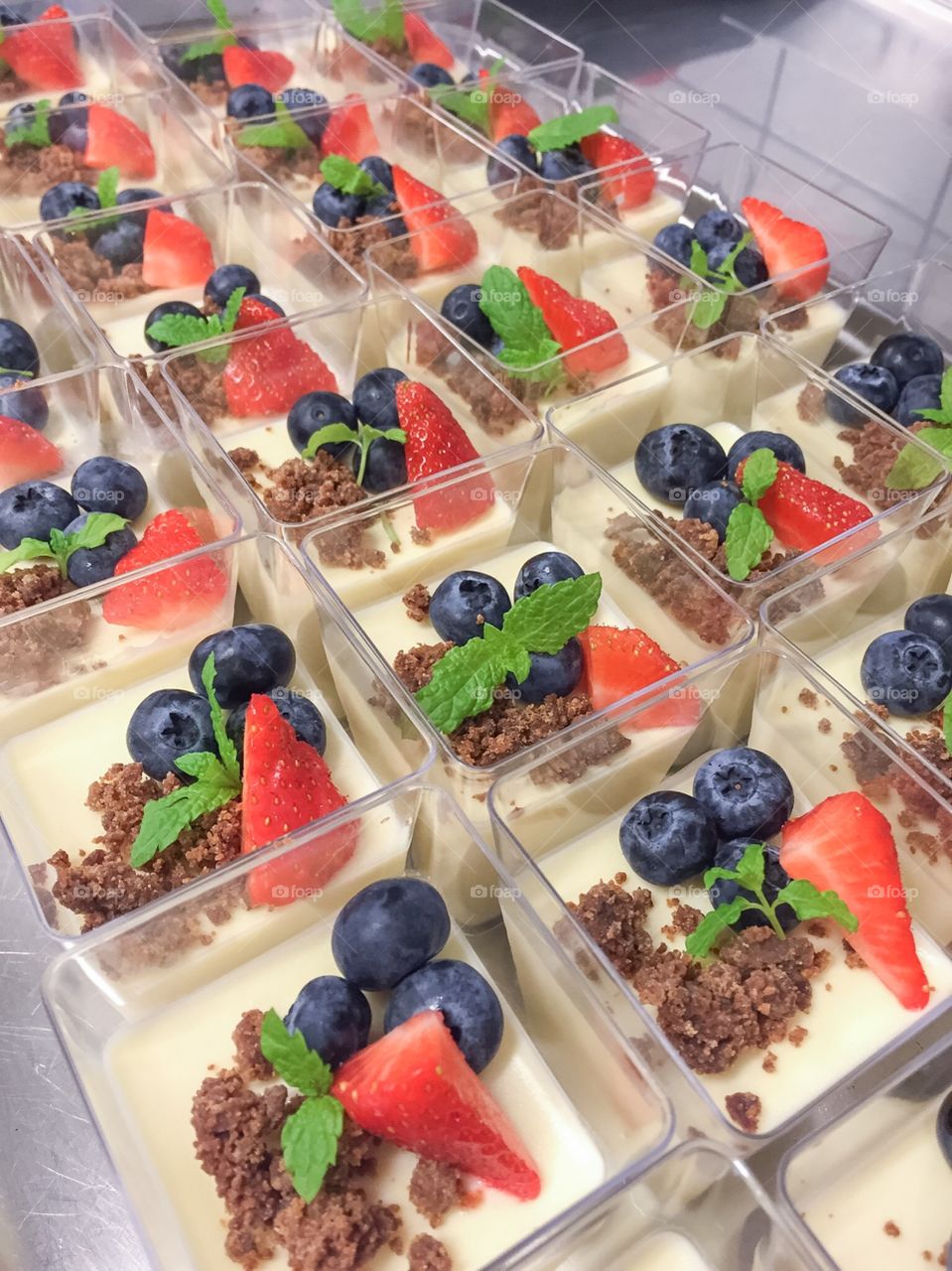 Pannacotta with chocolate, strawberries and blueberries.