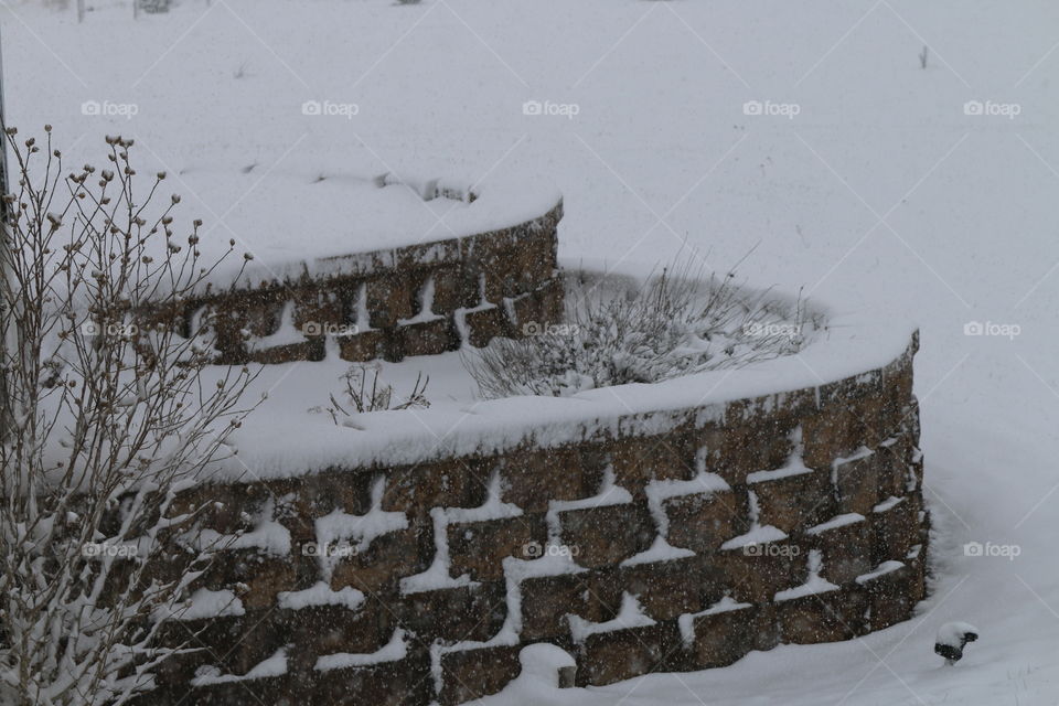 snow covered tiered wall