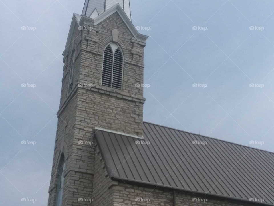 bell tower,grey sky,brown,roof tiles,steep