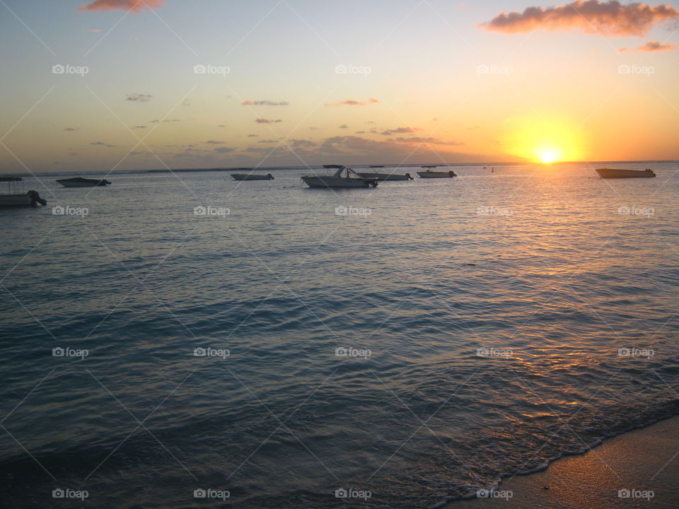Boats on the water as the sun goes down in Mauritius