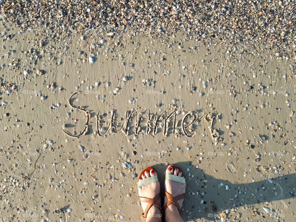 Feet on the sand beach