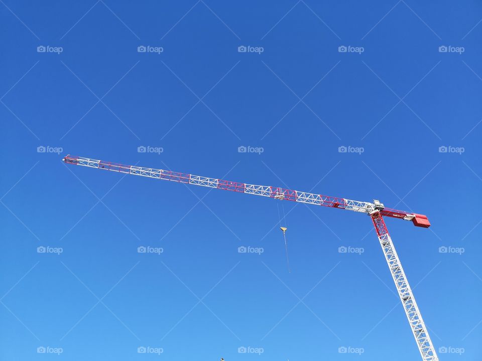 Construction crane with blue sky background