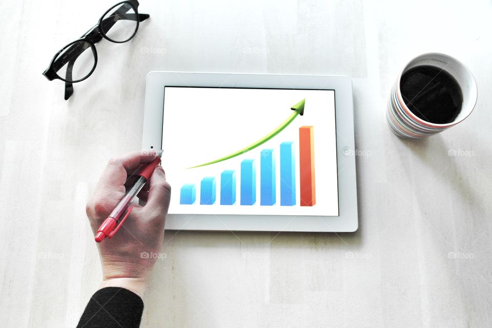 Computer desk with tablet. Business management and planning. Markets. Desk from above.