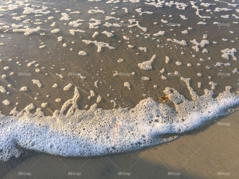 Tiny bubbles on the pristine beach.