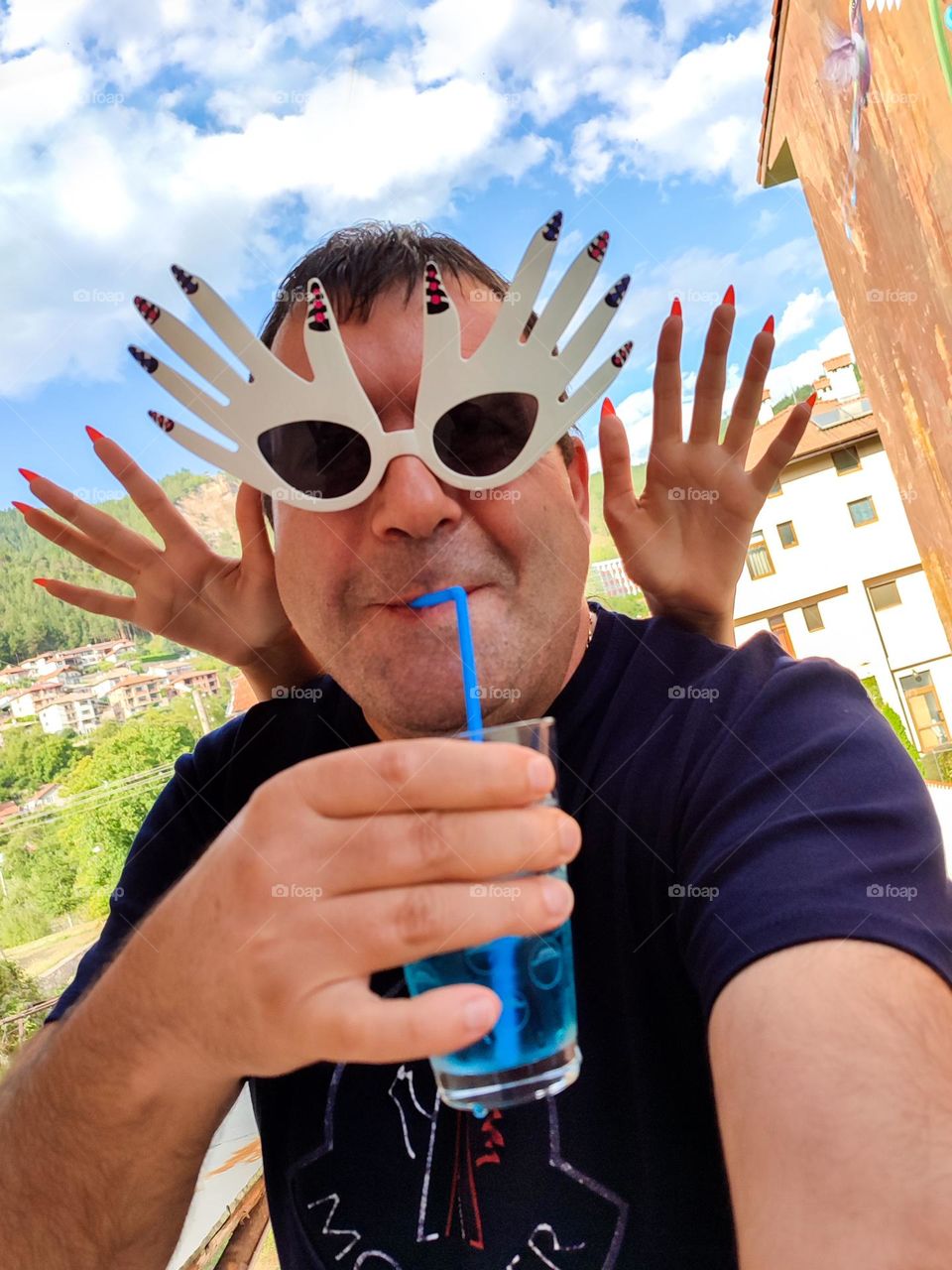 Energetic, Light-Hearted Funny Selfie with Cocktail and Sunglasses