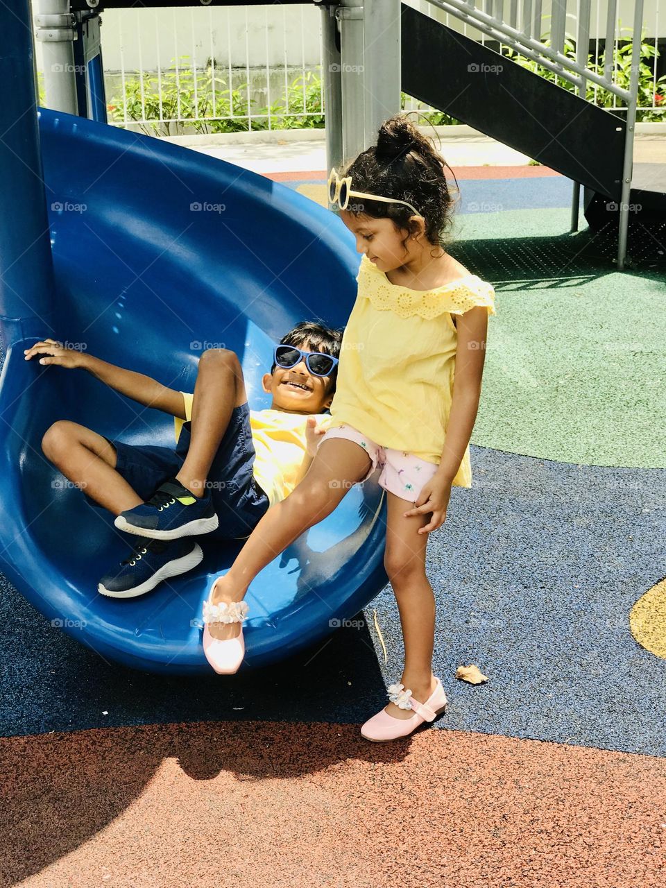 Funny girl and boy at playground 