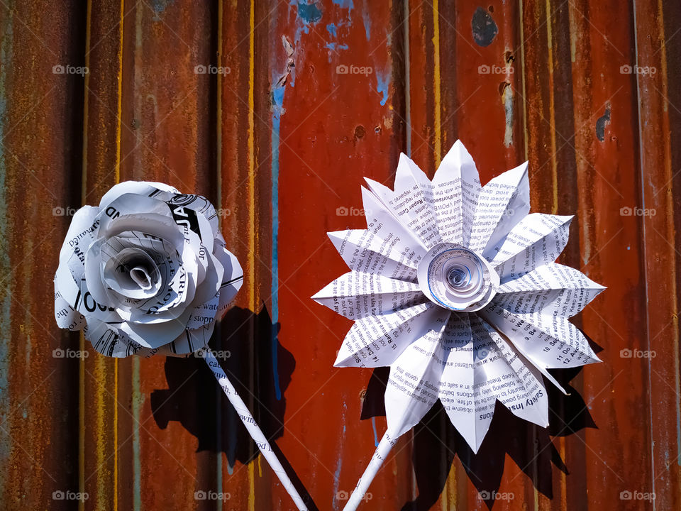 Flowers made of white paper against the backdrop of the old door.