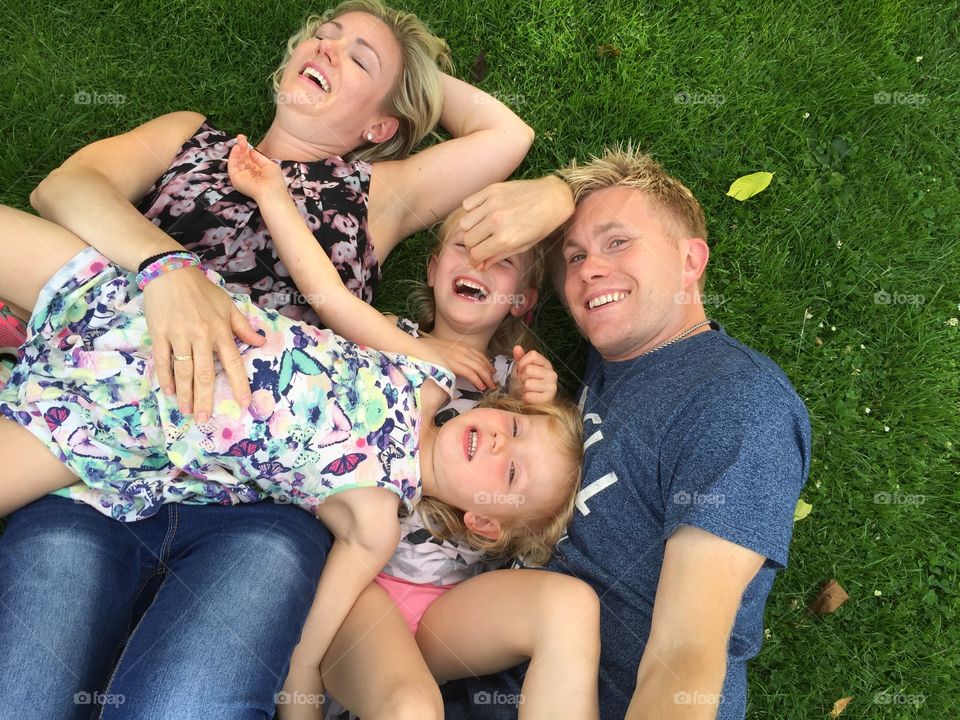 High angle view of family lying on grass