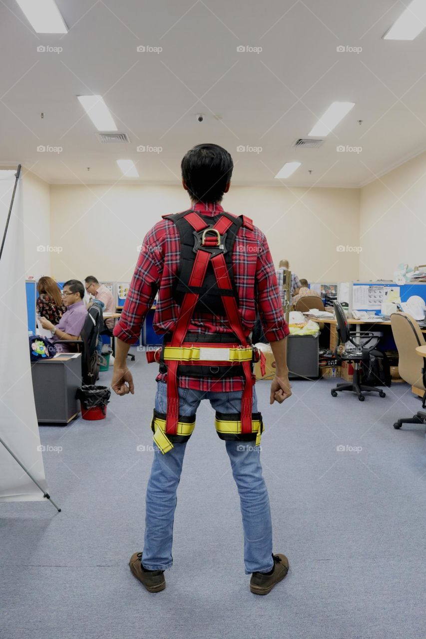 photo of a mountain climber wearing a full body harness, this tool is a fall protector