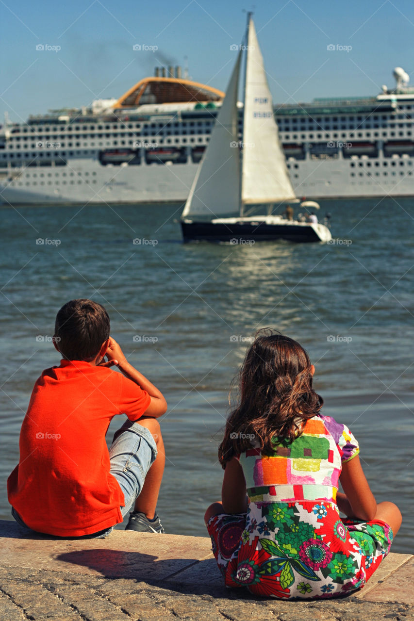 Kids sitting by the river