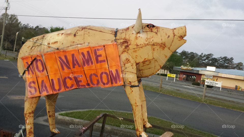 Giant metal pig advertising"No Name Sauce