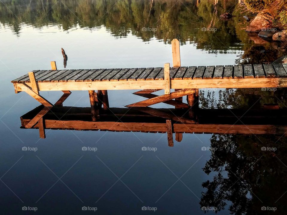 Reflection of pier on lake