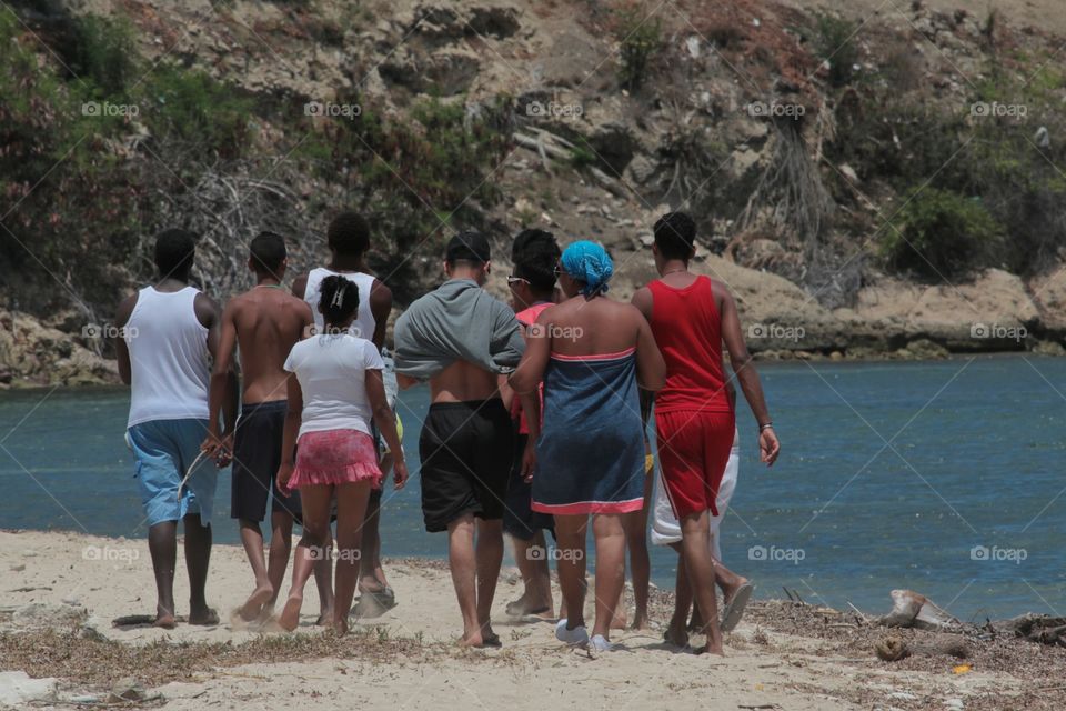 Group of local people walking on beach,Guantanamo,Cuba