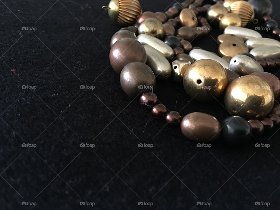 Metal craft beads at top right of frame